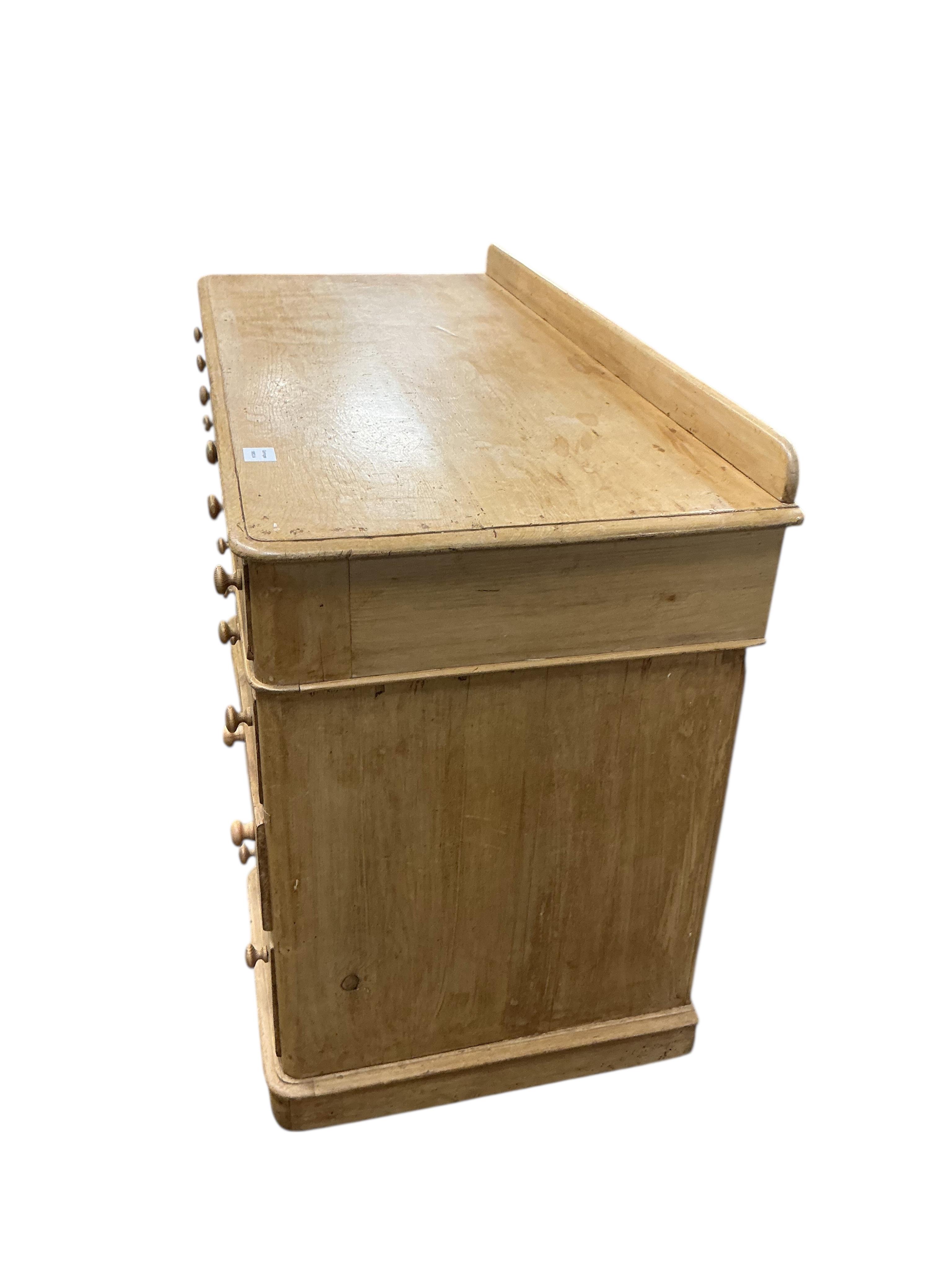 A Victorian pine pedestal desk, fitted with nine small drawers, width 122cm, depth 54cm, height 82cm